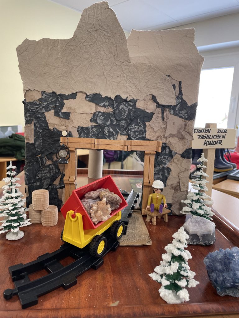 Adventskalenderbild aus der Kita Flachsröste - Käfergruppe - der rot/gelben Wagon, der ins gebastelte Bergwerk fährt